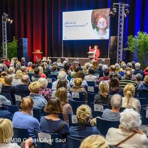 Publikum und Bühne auf der Messe Leben und Tod